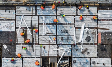 Workers are seen on a rooftop of a residential building under construction in Nanjing, China.