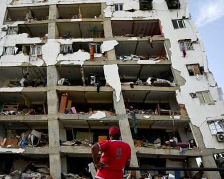A man looks astatine a damaged building