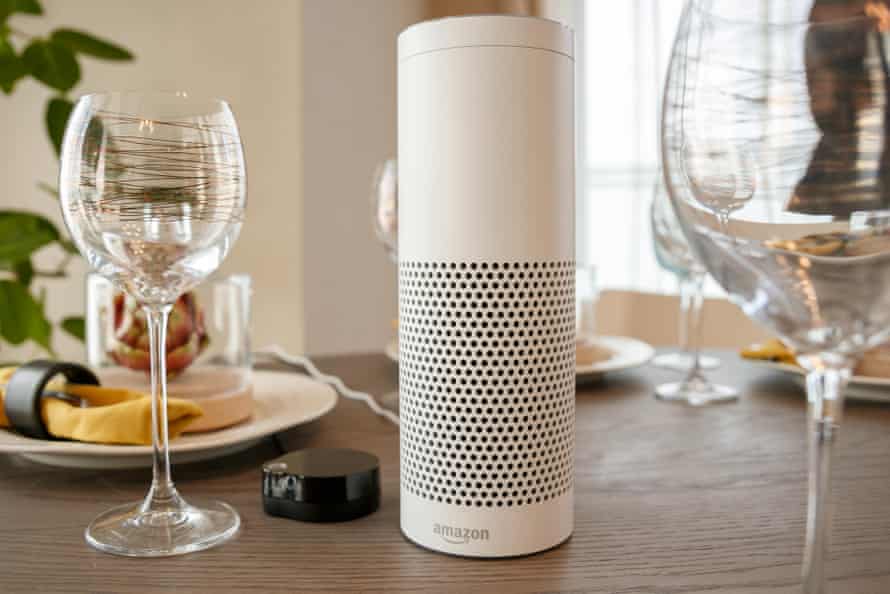 an amazon echo on a dinner table with wine glasses