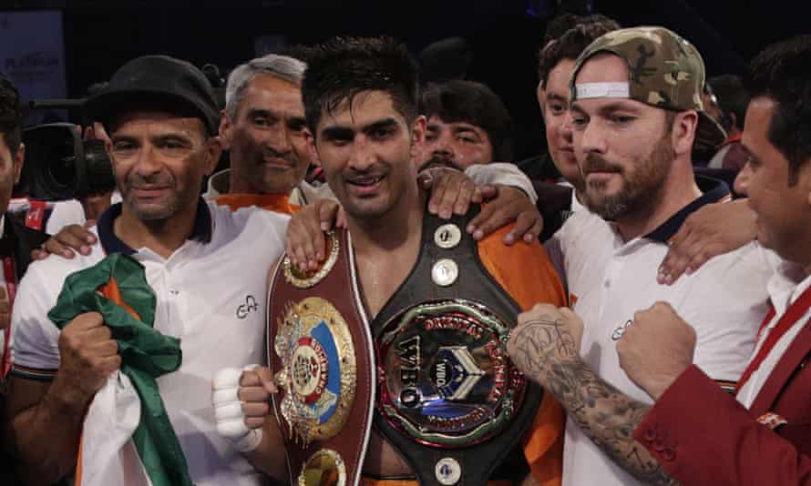 Vijender Singh with his two title belts after the match in Mumbai on Saturday.