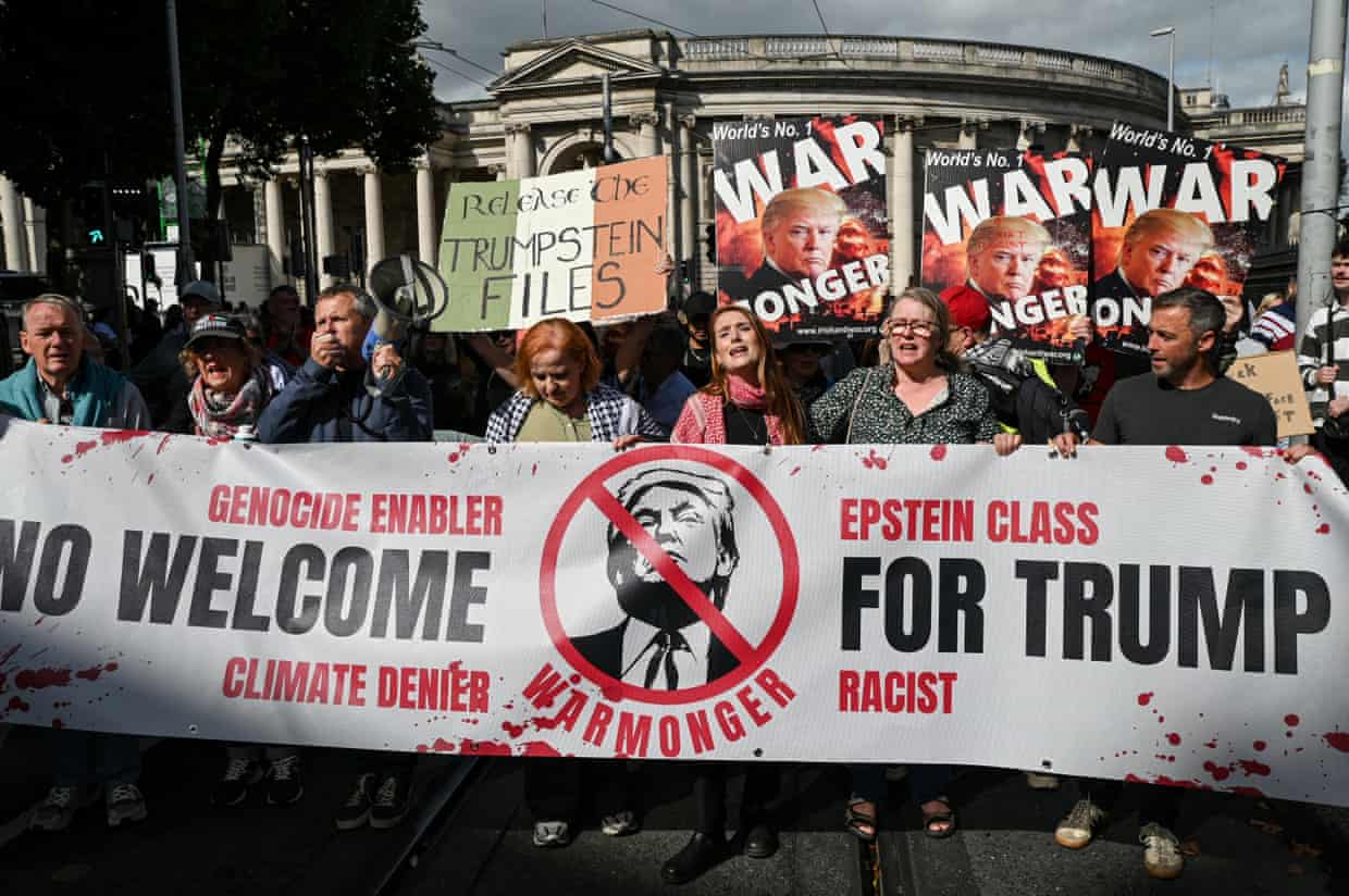 People hold a banner saying ‘No welcome for Trump: genocide enabler, climate denier, Epstein class, racist, warmonger’