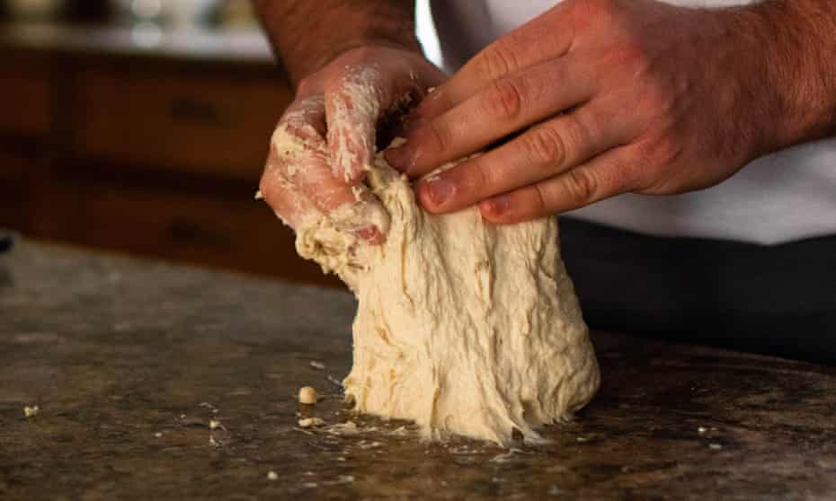 Man kneading bread dough