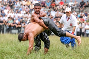 Men compete in an oil wrestling bout