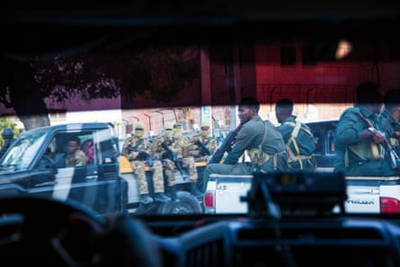 The threat from al-Shabaab is real – and unpredictable. Soldiers are pictured from within a secure vehicle during a journey around the Mogadishu.