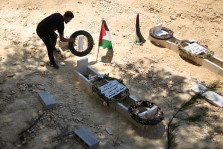 a man tidies a grave