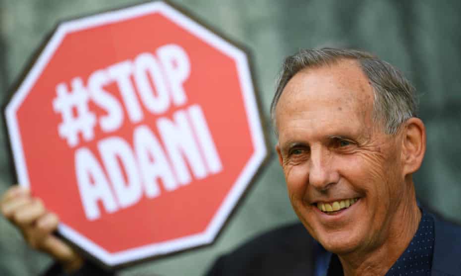 Former Greens senator Bob Brown in front of a "Stop Adani" sign in Canberra in 2017.