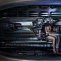 Album cover with a woman wearing almost nothing, plugged into a metal machine