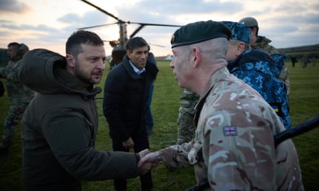 Volodymyr Zelenskiy and Rishi Sunak meet Ukrainian troops being trained at a military facility in Dorset, England. 