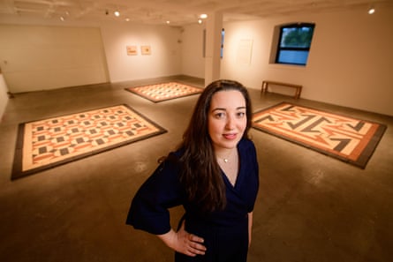 Dana Awartani standing in front of her recreation of an ancient bathhouse floor in Gaza