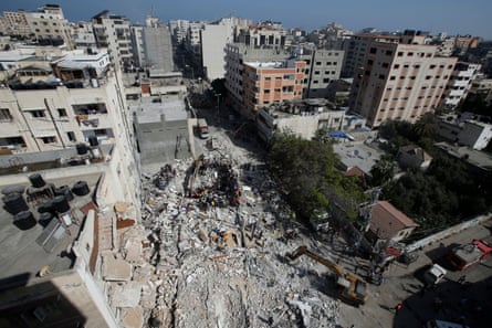 Rescuers search for people in the rubble of a building at the site of Israeli airstrikes.
