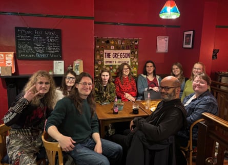 People sitting around a table smile at the camera
