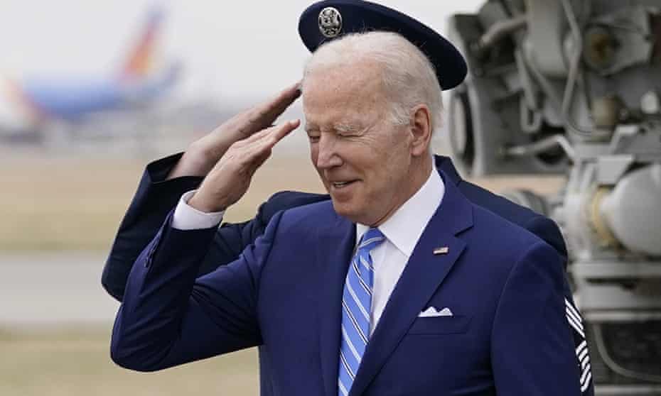 President Joe Biden salutes as he arrives on Air Force One at Des Moines international airport, in Des Moines Iowa, on Tuesday.