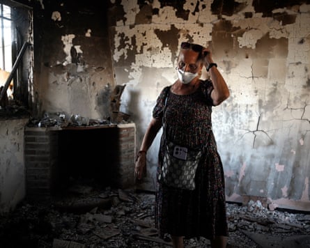 Concepcion Garcia enters her home for the first time after it was destroyed by wildfire.
