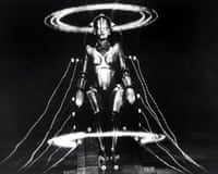 black and white film still of robot attached to wires