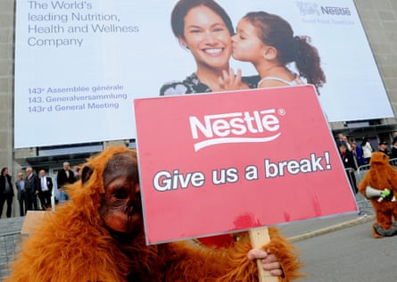 Greenpeace protestors dressed as orangutans demonstrate against palm oil harvested from rainforest destruction outside a Nestle shareholders’ meeting