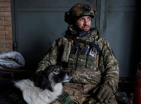 A Ukrainian serviceman rests in the frontline city of Bakhmut.