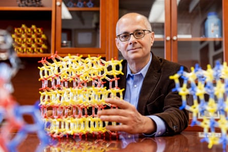 Omar Yaghi sat at a desk in front of some models of chemical molecules