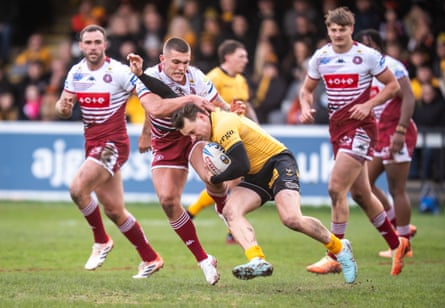 Castleford Tigers’ Blake Taaffe is tackled by Wigan Warriors’ Brad O’Neill during the Super League match.