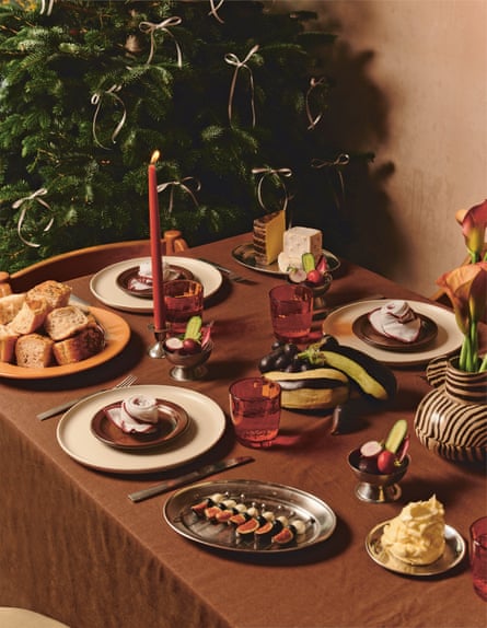 A table set for a festive feast with a Christmas tree in the background