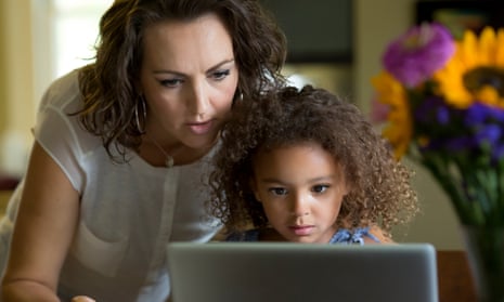A mother and daughter using a laptop