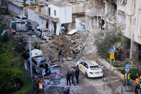 Israeli security and rescue forces respond at the site of an Iranian missile strike in Tel Aviv, Israel, on 24 March 2026.