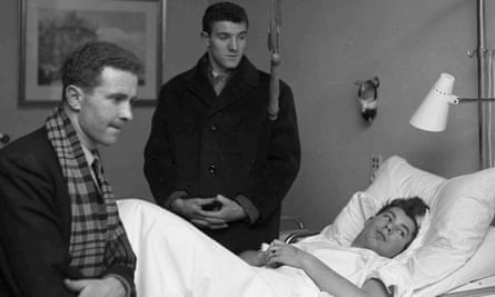 Harry Gregg, left, and Billy Foulkes, visiting their injured Manchester United team mate Ken Morgan in February 1958, shortly after a plane carrying the team crashed at Munich airport.