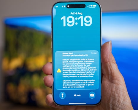 A UK government alert seen in Welsh on an iPhone warning of the risk of wildfires on 14 August 2026 in Cardiff, Wales