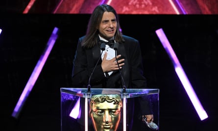 Slavov accepts the Music award at the 2024 Baftas.