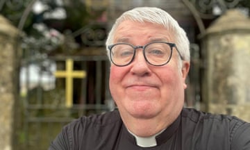 Selfie of Reverend John Gillibrand wearing his clergy dog collar with a neutral expression.