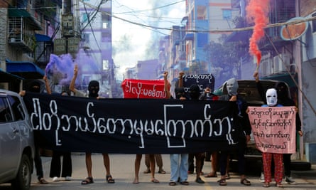 Young demonstrators hold a banner reading “we will never be frightened” at a protest in Yangon on Monday.