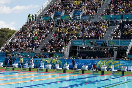 Athletes walk on to the pool deck for a men’s S7 50m freestyle heat