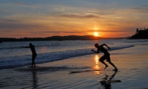 Surfers on Tofino’s Long Beach on Vancouver Island, British Columbia