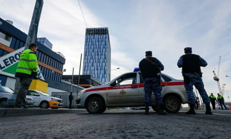 Los miembros de los servicios de seguridad montan guardia cerca del sitio de un edificio dañado después del ataque informado.