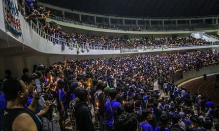 Indonesia football stadium disaster: pressure grows over police response | Indonesia 6 Football supporters pray at the Jatidiri Stadium in Semarang. They lit candles as a tribute to the victims of the crush.
