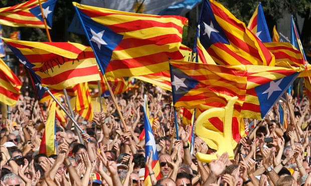 People wave separatist flags at a rally in Barcelona
