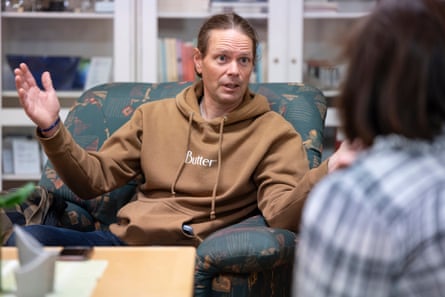 Lars-Marcus Kuhmunen, wearing a light brown hoodie, talking to Miranda Bryant from the Guardian