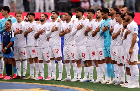 Players of Iran line up for the national anthem.