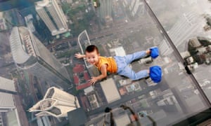 A boy plays on the glass at Thailand’s first skywalk in Bangkok
