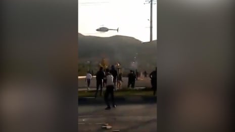 Video shows helicopter flying past crowds during protest in Iran