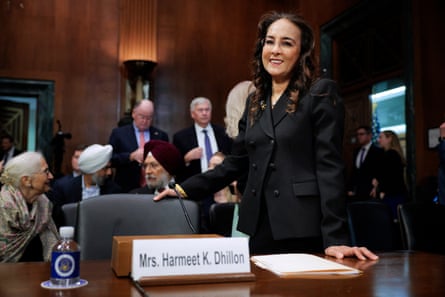 a woman smiles while standing at a table