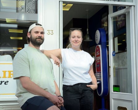 Marius Baltaitis with a beard and a green T-shirt poses with Mairi Livsey who leans her arm on him.