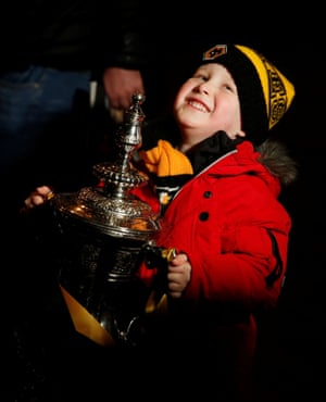 A young Wolves fan poses with a replica of the FA Cup trophy before their 2-1 win over Manchester United at Molineux.
