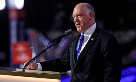 a man in a suit speaks into a microphone