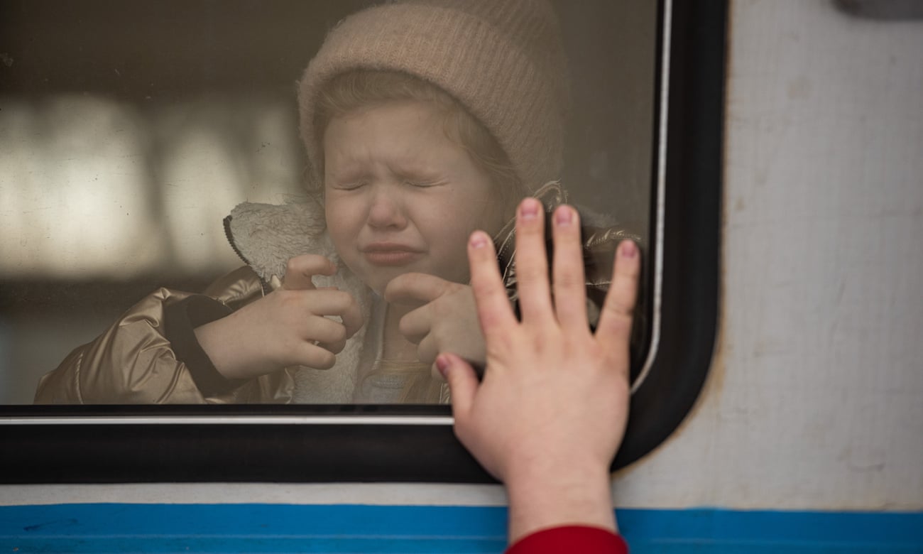 A young girl cries as a man says goodbye to his daughter at the railway station in Lviv