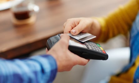 Person using bank card on contactless payment terminal