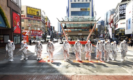 South Korean soldiers spray disinfectant to prevent the spread of Covid-19 in Daegu, South Korea