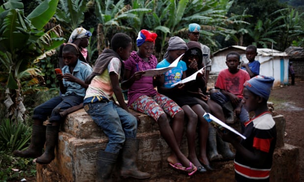 Children gather and read school books in Boucan Ferdinand, Haiti