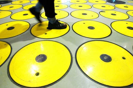 Feet walk over a floor covered in yellow circles