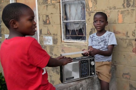 Boys holding an old-fashioned radio