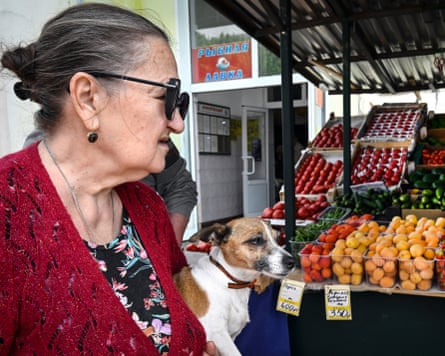 A Moscow resident inspects fruit at a local market